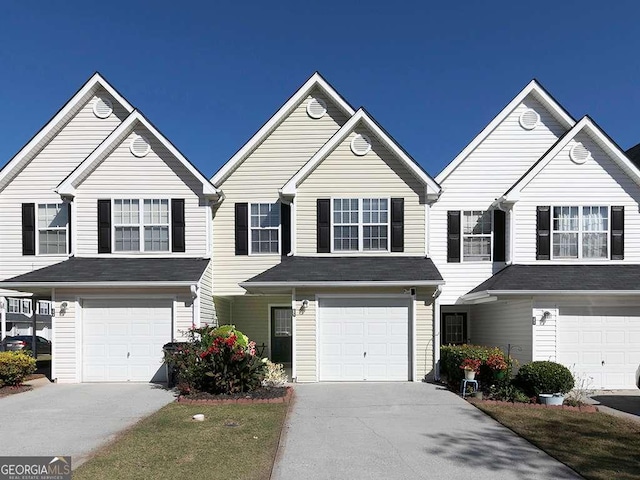 view of front facade with concrete driveway and an attached garage