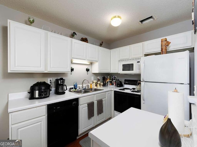 kitchen with light countertops, white appliances, a sink, and white cabinets