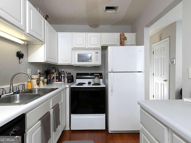 kitchen with white appliances, white cabinetry, light countertops, and a sink
