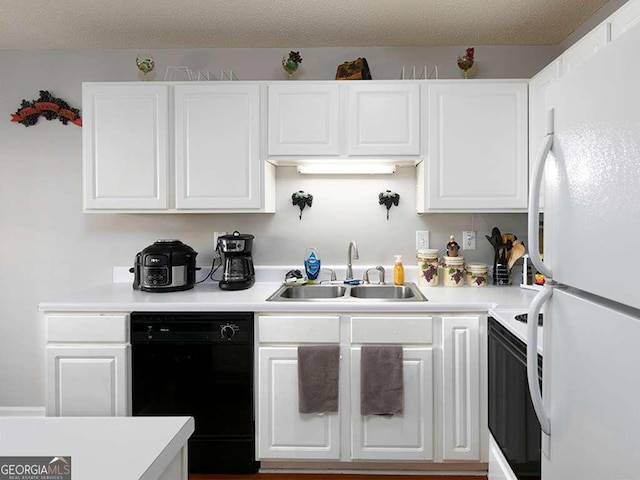 kitchen with white cabinets, white appliances, light countertops, and a sink