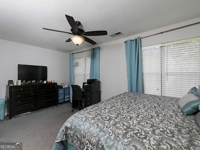 carpeted bedroom featuring a ceiling fan, visible vents, and a textured ceiling