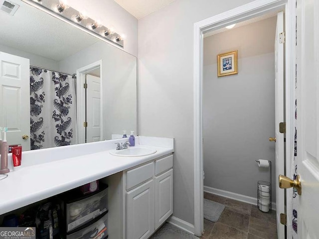 bathroom with visible vents, vanity, and baseboards