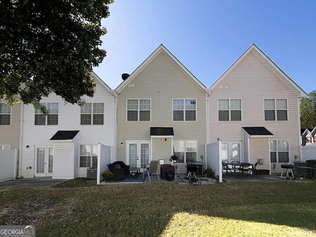 back of house featuring a yard, french doors, and a patio area