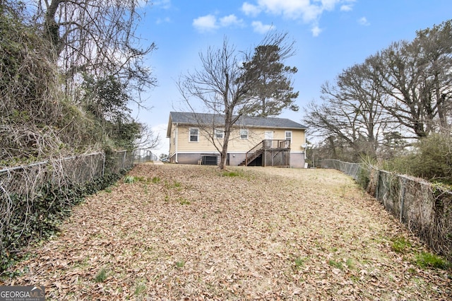 rear view of property with stairway and fence