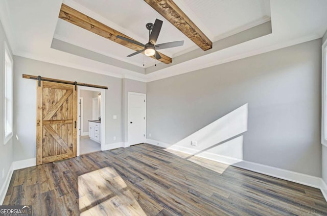 107 Bob White Dr, Calhoun, GA 30701 - unfurnished bedroom with a barn door, a raised ceiling, wood finished floors, connected bathroom, and beam ceiling