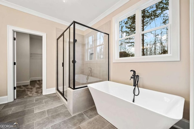 107 Bob White Dr, Calhoun, GA 30701 - bathroom featuring a shower stall, a soaking tub, a walk in closet, crown molding, and tile patterned flooring