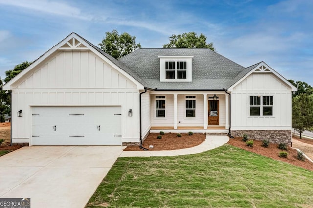 modern farmhouse style home featuring roof with shingles, covered porch, concrete driveway, board and batten siding, and a garage