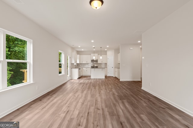 141 Roxeywood Way, Winder, GA 30680 - unfurnished living room featuring light wood-style floors, baseboards, and recessed lighting