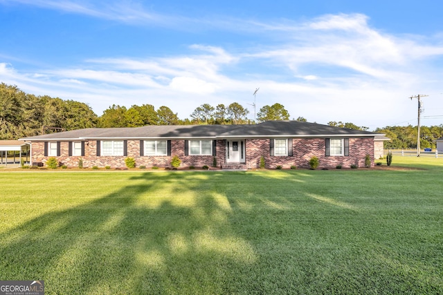 ranch-style home featuring a front yard and brick siding