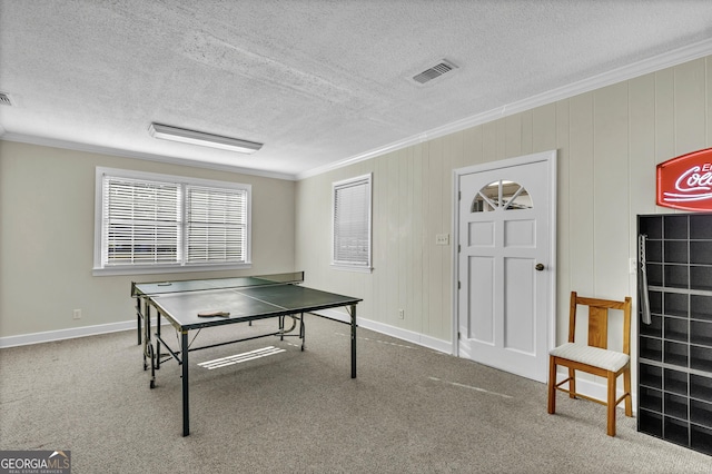 playroom featuring carpet floors, visible vents, crown molding, and a textured ceiling