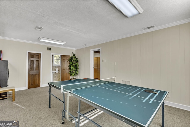 playroom with a textured ceiling, carpet floors, and visible vents