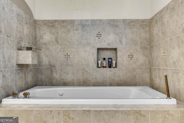 bathroom featuring tiled bath and tile walls