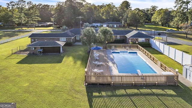 community pool featuring fence private yard and a lawn