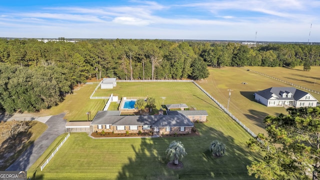 aerial view featuring a rural view and a wooded view