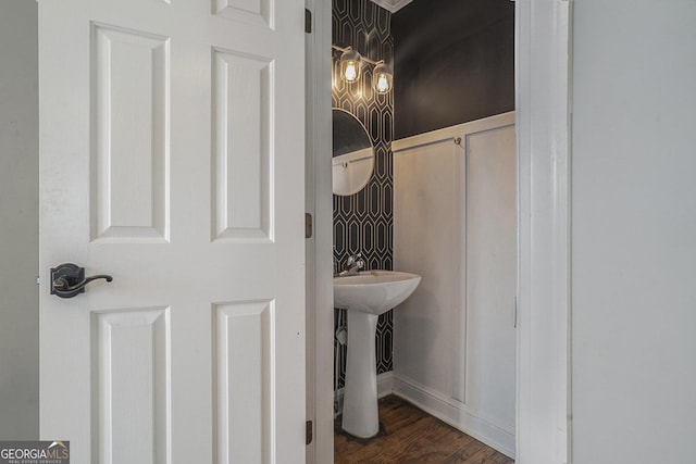 bathroom with baseboards and wood finished floors