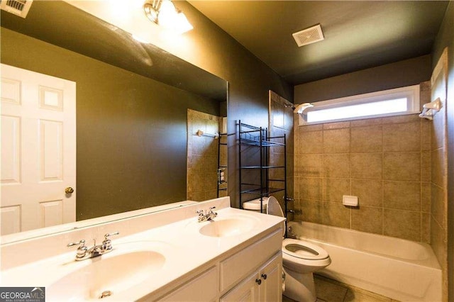 bathroom featuring shower / bath combination, a sink, and visible vents