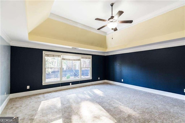 unfurnished room featuring light carpet, visible vents, baseboards, a tray ceiling, and crown molding