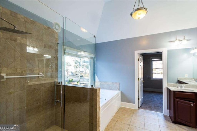 full bath featuring a garden tub, lofted ceiling, vanity, a shower stall, and tile patterned floors