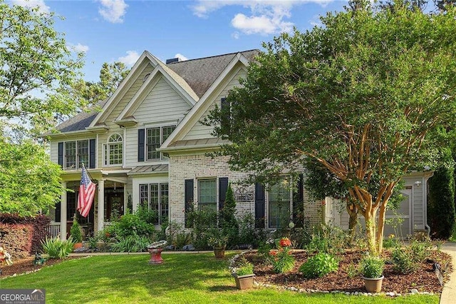 view of front of home with brick siding and a front yard