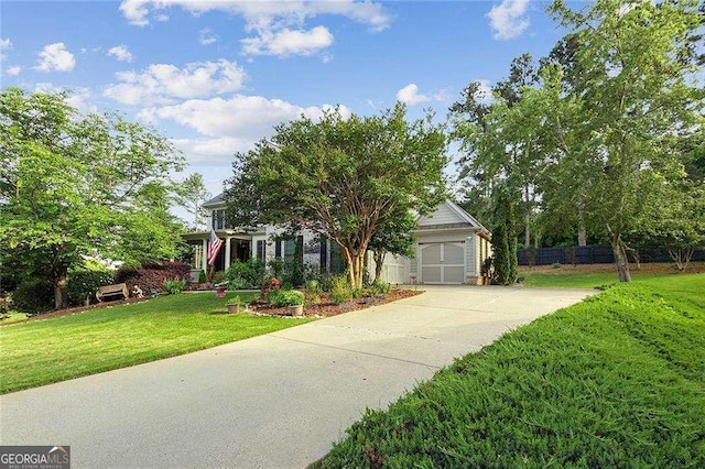 view of front of home featuring driveway, an attached garage, and a front yard