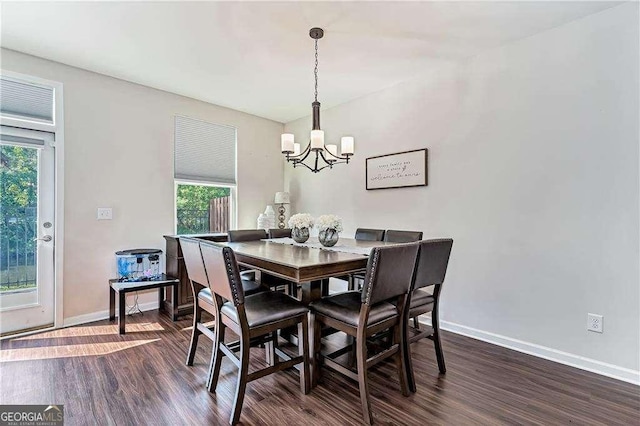 dining area with a notable chandelier, baseboards, and dark wood-style flooring