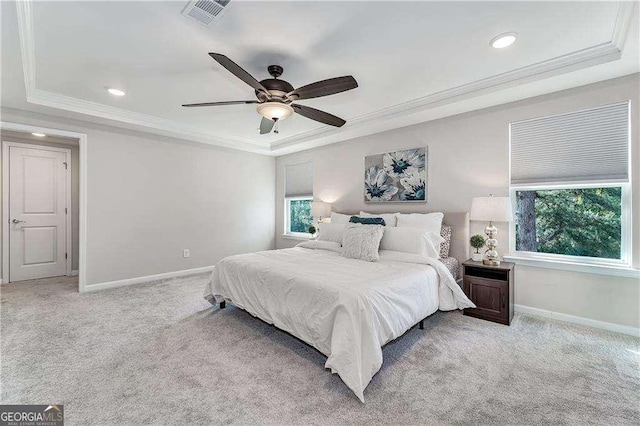 bedroom featuring light carpet, visible vents, a raised ceiling, and ornamental molding