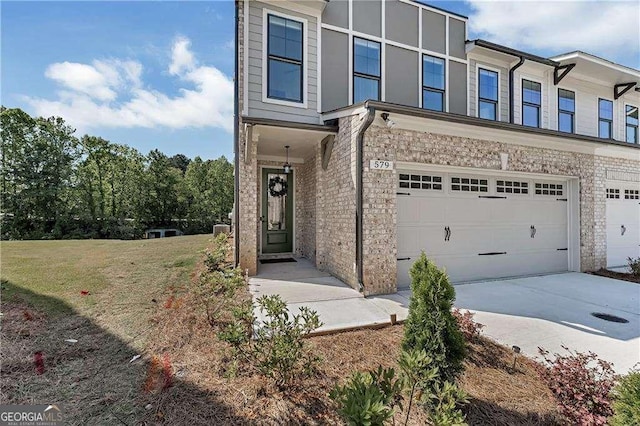 view of property featuring driveway, an attached garage, and a front lawn