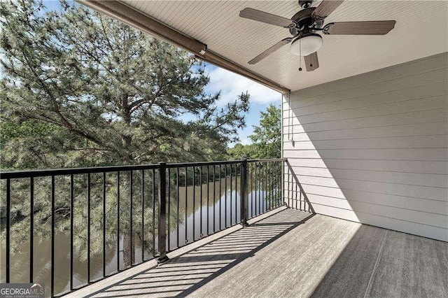 balcony with a water view and ceiling fan