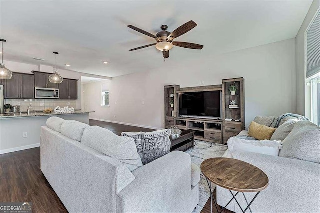 living area with recessed lighting, dark wood-style flooring, ceiling fan, and baseboards