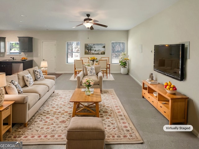 living room with baseboards and a ceiling fan