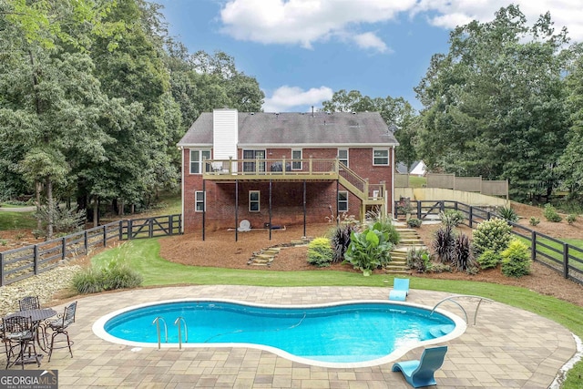 view of swimming pool featuring a fenced backyard, stairs, a wooden deck, a fenced in pool, and a patio area