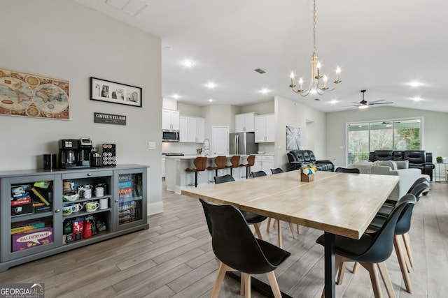 dining room featuring visible vents, a ceiling fan, lofted ceiling, light wood-type flooring, and recessed lighting