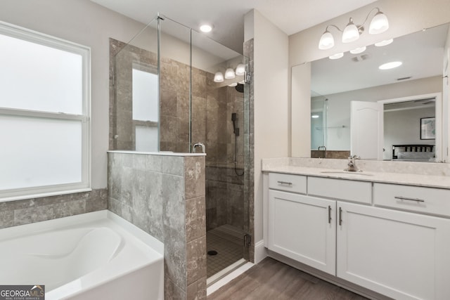 full bath featuring a garden tub, wood finished floors, vanity, visible vents, and a stall shower