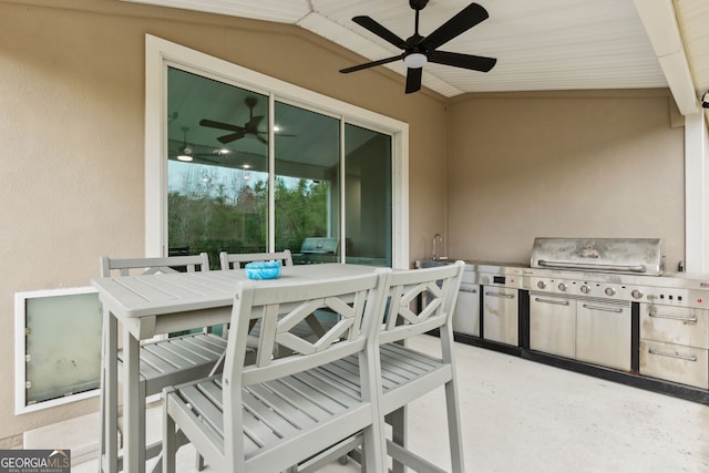 view of patio with outdoor dining space, an outdoor kitchen, and a ceiling fan