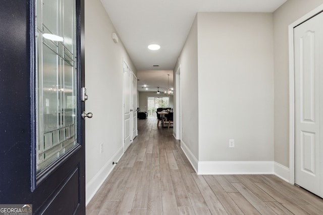 entryway with light wood-style floors and baseboards