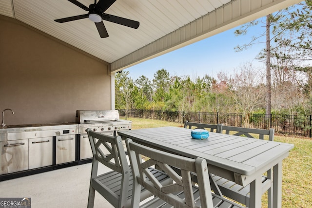 view of patio / terrace featuring outdoor dining area, a fenced backyard, area for grilling, a sink, and a ceiling fan