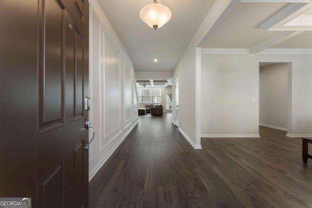 hall featuring dark wood-type flooring and baseboards