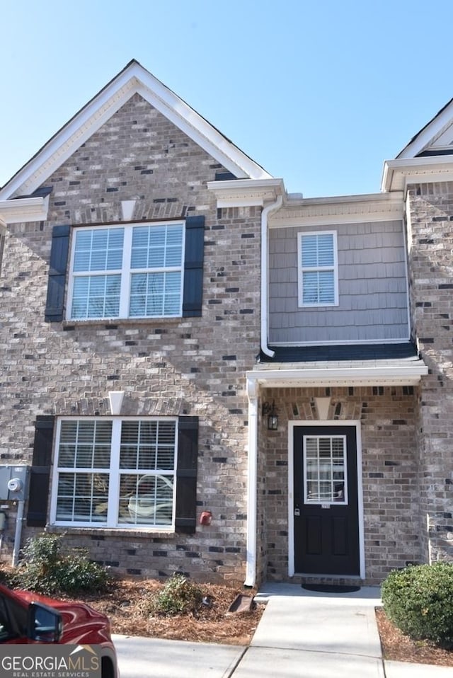 townhome / multi-family property featuring brick siding