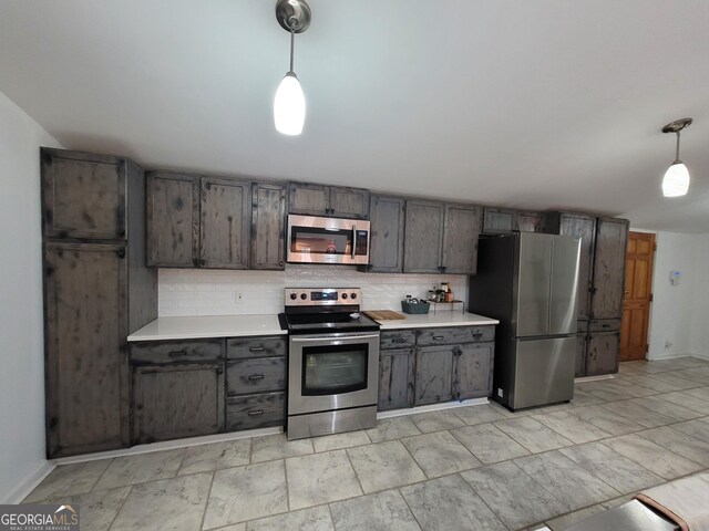 kitchen with tasteful backsplash, dishwasher, decorative light fixtures, gray cabinets, and a sink