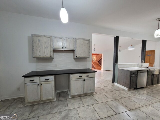 kitchen with stainless steel appliances, light countertops, and pendant lighting