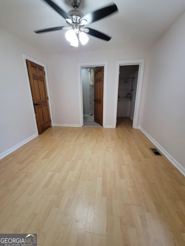 stairs with a chandelier, high vaulted ceiling, wood finished floors, and baseboards