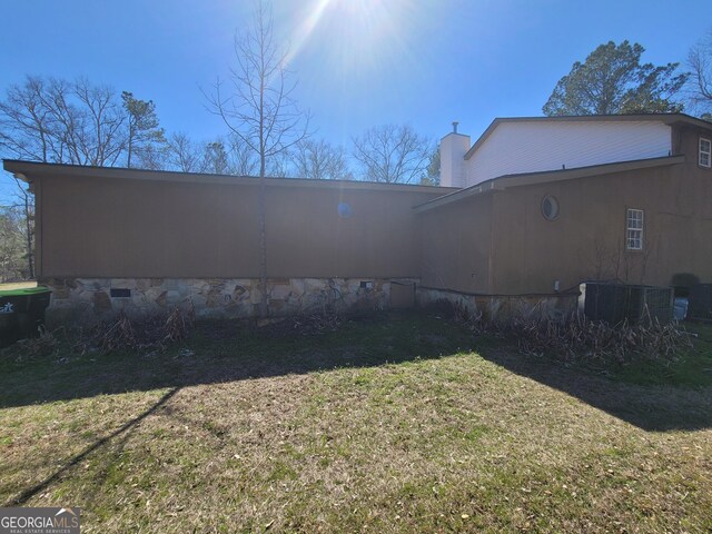 view of side of property with a wooden deck and central air condition unit