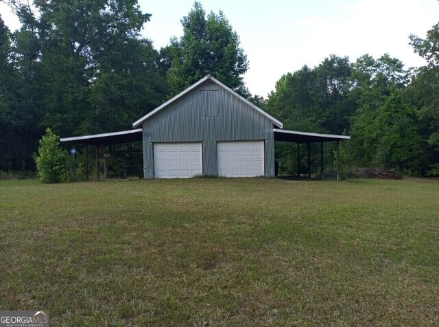 garage featuring driveway and a detached garage