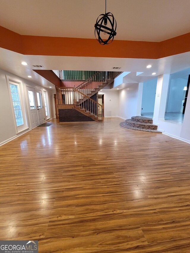 foyer entrance with recessed lighting, wood finished floors, visible vents, baseboards, and stairs