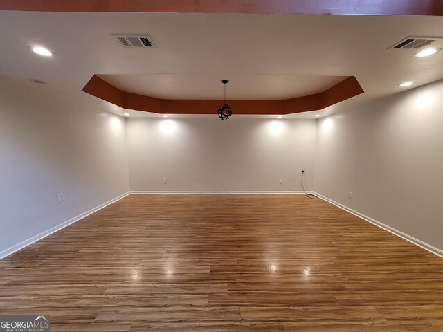 interior space with a towering ceiling, light wood-style floors, and baseboards