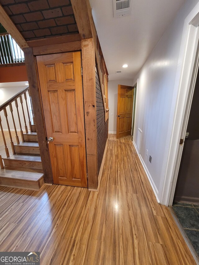 stairs featuring baseboards, a high ceiling, and wood finished floors