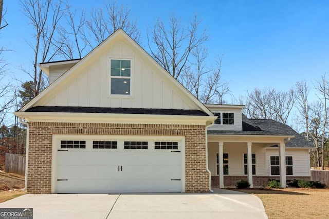 view of front of property with a garage, board and batten siding, and brick siding