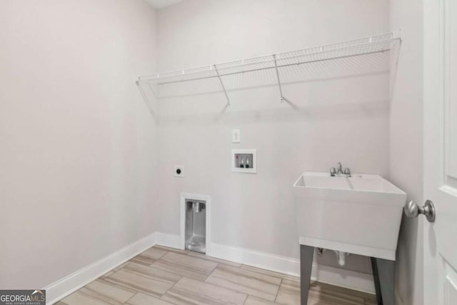 clothes washing area with laundry area, hookup for a washing machine, baseboards, and electric dryer hookup