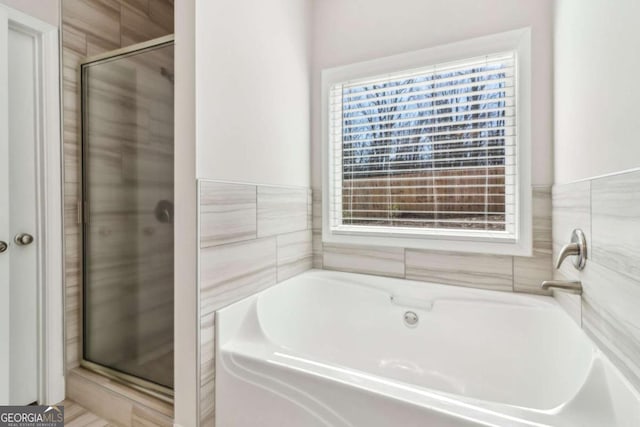 bathroom with a garden tub and a stall shower