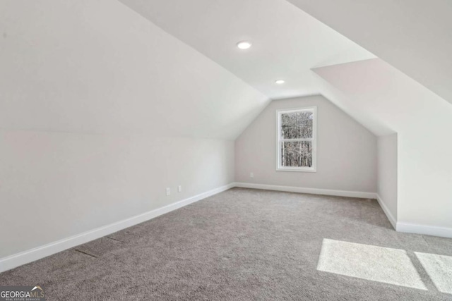 bonus room with lofted ceiling, recessed lighting, light colored carpet, and baseboards